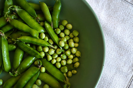 Green shoots of young peas, flowers and pods on a dark wooden background. selective focusingの写真素材