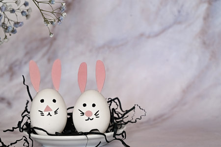 Easter composition of eggs and flowers on a light background. Easter Bunny. A gentle greeting card...