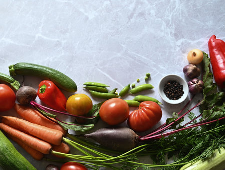 food cooking background. Fresh rosemary, cilantro, basil, cherry tomatoes, peppers and olive oil, spices herbs and vegetables at black slate table. Food ingredients top view.の写真素材