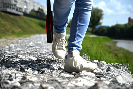 a woman photographer with a camera in her haa woman photographer with a camera in her hands walks through the streets of the citynds walks through the streets of the cityの写真素材