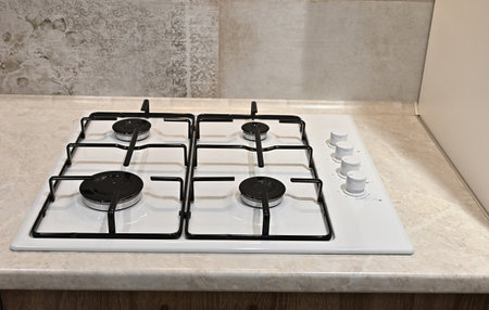 Clean white surface of the gas stove. Gas stove control panel close up, selective focus.の写真素材