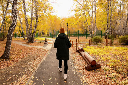 a girl go to autumn forestの写真素材