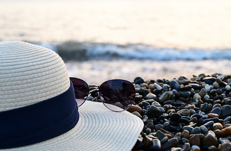 Sunglasses and hat on the beach. the concept of travel.の写真素材