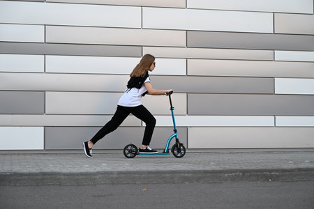Beautiful and blonde girl practicing long board on the roadの写真素材