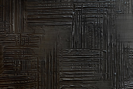 Pattern of black decorative and textured plaster. Construction and finishing materials for repairs of walls in apartments, houses and offices. Background and texture for design and decoration.の写真素材