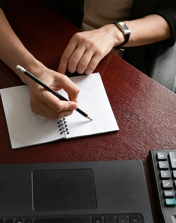 A woman in a modern office looks at graphs and diagrams. Solving economic problems. burnout.