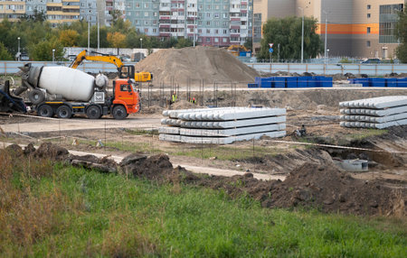 Concreting work at the construction site. Construction workers pour liquid concrete from cement...