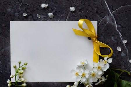 Floral layout on a vintage white wooden background and computer partially. Spring flowers, woman freelancing concept. View from above.の写真素材