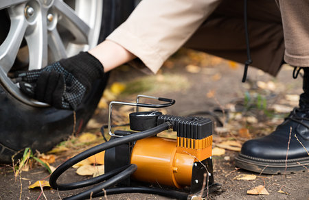 Man car inspection Measure quantity Inflated Rubber tires car.Close up hand holding machine Inflated pressure gauge for car tire pressure measurement for automotive, automobile imageの写真素材