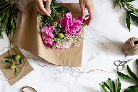 pink persian buttercup flowers in hands. Curly peony ranunculus. Empty spaceの写真素材