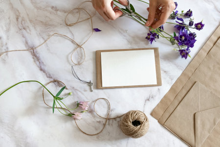 Florist makes a bouquet. A woman makes a bouquet of peonies, a bouquet of kraft paper.
