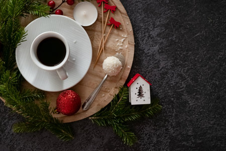 Top-view shot of chic gift boxes, adorned with green bows, gold and green ornaments, star decorations, confetti on black backdrop, space for your festive wishes or promoの写真素材
