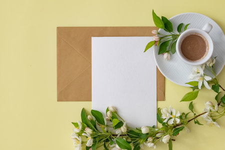 A cozy workspace features a notebook with a pencil, a cup of coffee on a saucer, and delicate...