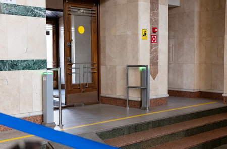 Entrance to the modern station building with automatic gates and daytime security measuresの写真素材
