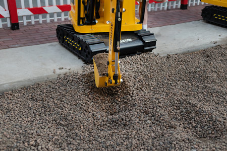 Mini excavator at the construction site. Compact construction equipment for earthworks