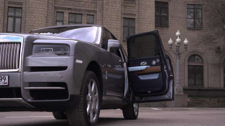 Moscow, Russia - 13 03 2020: The door of an expensive Rolls Royce Cullinan car automatically closes. The rich man got into his exclusive and fancy car and the door closed behind him.のeditorial素材