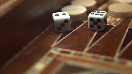 Close-up of a game of backgammon. Macro footage of how dice are thrown. On dice, the number eight is...