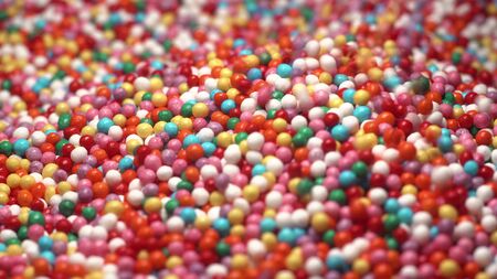 Colorful sprinkles sugar candy fall on table. multi-colored dragee fall into anothe multicolored balls. Red blue green yellow white orange.の写真素材