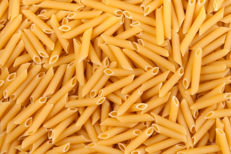 Background of uncooked Penne pastaの写真素材