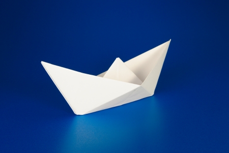 Paper boat over blue backgroundの写真素材