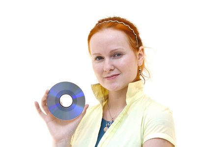 redhead young woman holding a CD in her handの写真素材