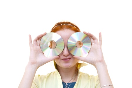 redhead young woman holding a CD as eyesの写真素材