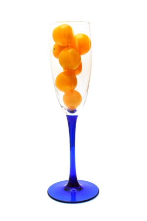 Glass is filled by yellow tomatoes isolatedの写真素材