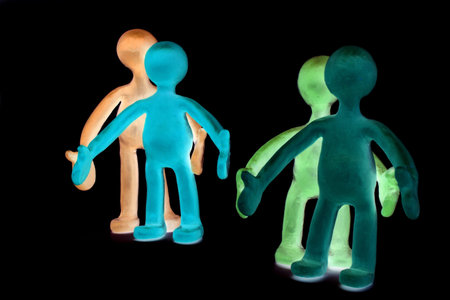 Shaded plasticine puppets pair standing near each other