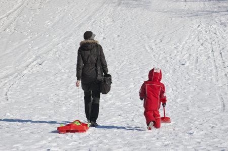 Mother and child going to slide from hill