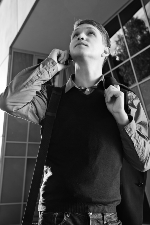 Shaded teacher is speaking by telephone with colleagueの写真素材