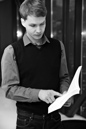 Shaded student reading sentences from book to rememberの写真素材