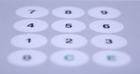 Wide white buttons on working desktop partially shadedの写真素材