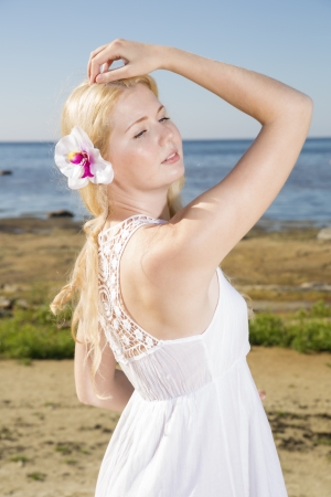 Youthful woman in dress with flower in hairsの写真素材