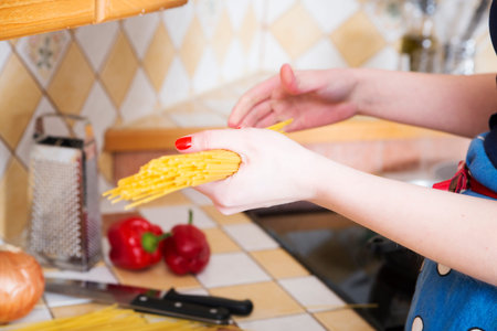 Woman hold pack of unboiled noodles at handsの写真素材