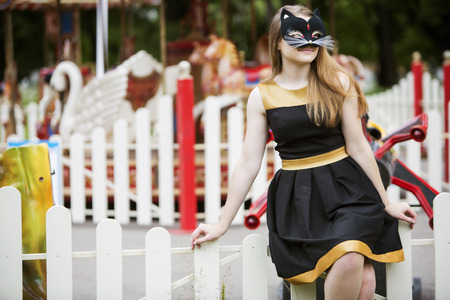 Young woman  with mask on empty carousel backgroundの写真素材