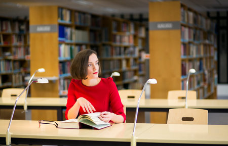 Young woman in thought in library looking left