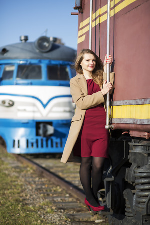 Woman at  train wagon stairs hold on boundaryの写真素材