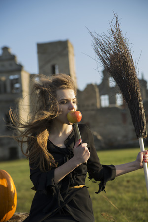 Witch with pale skin eat apple on knifeの写真素材