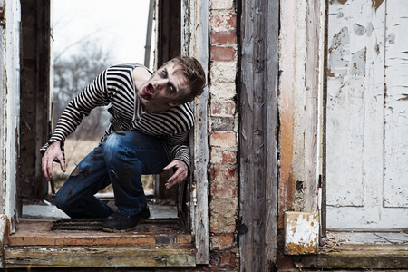 Evil looking possessed man in destroyed buildingの写真素材