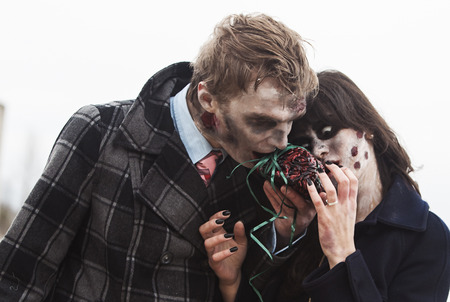 Zombie looking couple is eating a brainの写真素材