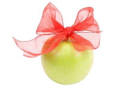 green apple with a red ribbon on white backgroundの写真素材