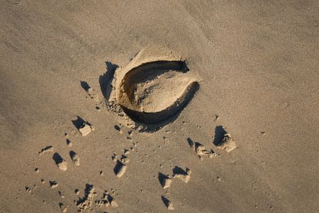 Trace from a horseshoe on sandの写真素材