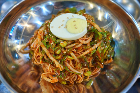 Spicy noodle, topped with egg sprinkled with sesame, famous in Jeju Island, South Korea.の写真素材