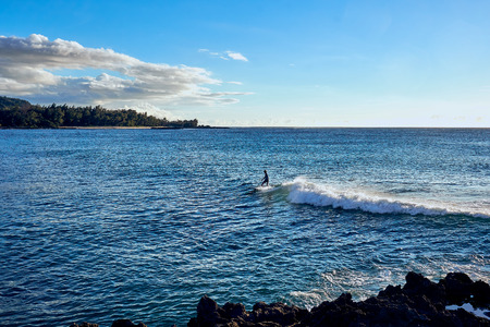 O'ahu, Hawaii, USA - August 4, 2017 : A surfer enjoying the waves at the ocean nearby  a resort.のeditorial素材