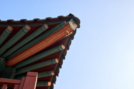 A close-up of the corner of traditional Korean kiwa decorated with variety of colors with an empty...