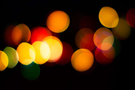 Evening defocused christmas lights boche black background bokehの写真素材