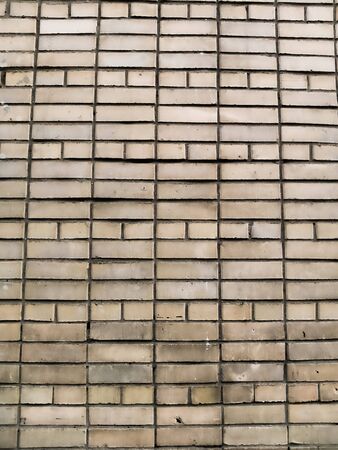 Gray brick wall with traces of destruction and dirty texture.の写真素材