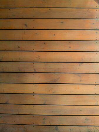 The texture of the wood horizontal narrow boards are light brown in color. Old shabby wooden background.の写真素材