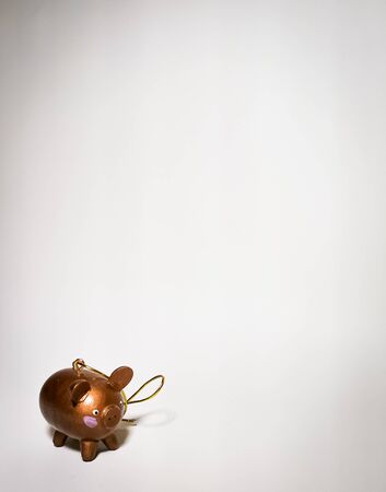 A pig is a symbol of wealth in the east. Close-up of a wooden pig toy. Space for your text.の写真素材