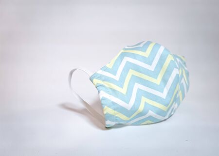 ndividual protective fabric mask in pastel colors on a gray background.の写真素材